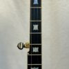 Gold Tone OB-2 JM fretboard showing bowtie inlays with professional capo attached