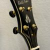 Angled view of Gold Tone OB-2 JM headstock showing diamond inlay and Gotoh tuning machines
