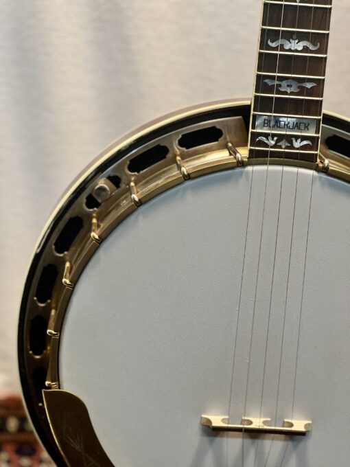 Multiple views of a 2006 Gibson RB-75 JD Crowe Blackjack banjo showing mahogany neck and resonator with antique red finish, exclusive Blackjack mother-of-pearl inlays, copper-flashed satin gold hardware, and original Gibson case