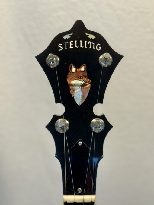 Stelling Red Fox banjo headstock showing red fox inlay and Stelling logo on black ebony.