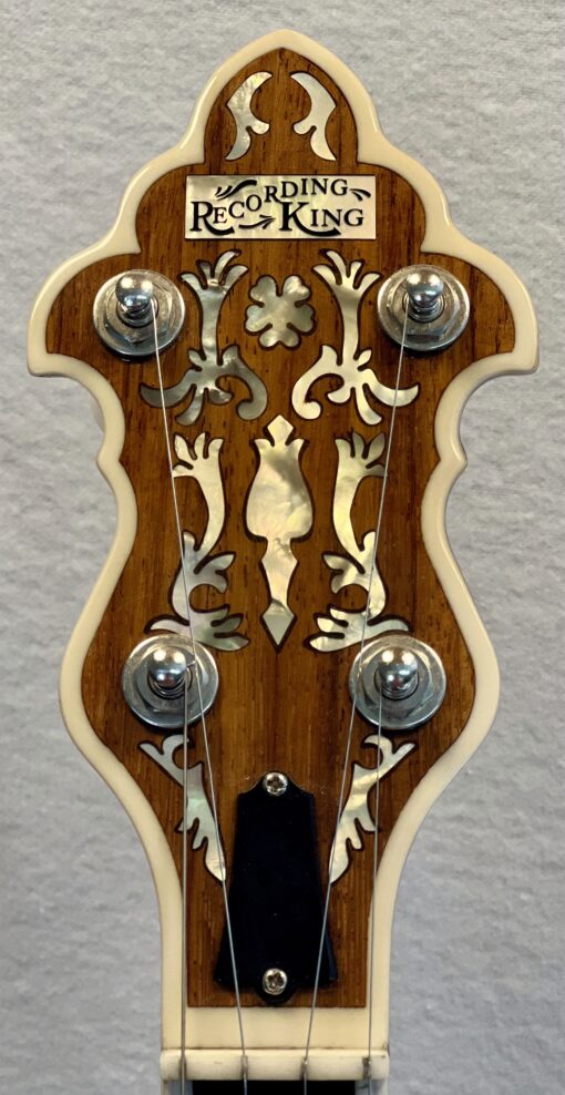 Recording King RKR-80 peghead detail featuring ornate floral mother-of-pearl inlay and Recording King logo on rosewood overlay