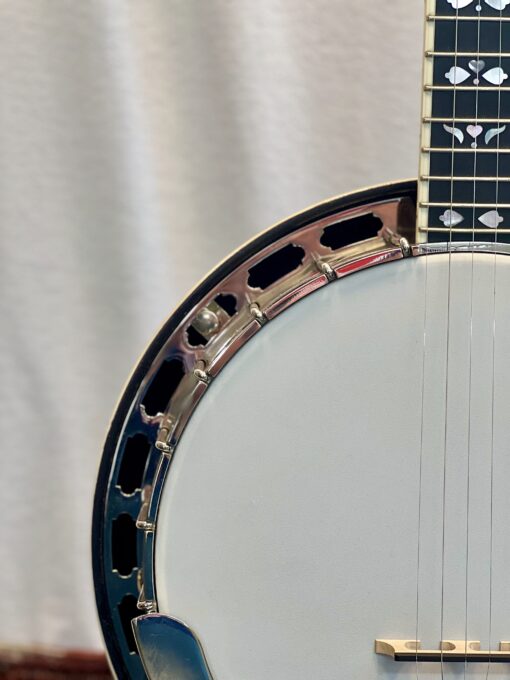 Side profile of Recording King RKR-80 banjo showing mahogany resonator rim and nickel-plated tension hoop brackets