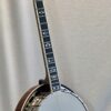 Three-quarter angle view of Recording King RKR-80 showing overall banjo profile and mahogany resonator finish