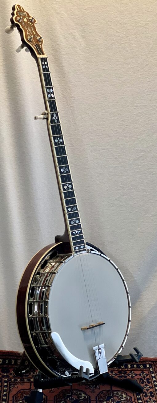 Three-quarter angle view of Recording King RKR-80 showing overall banjo profile and mahogany resonator finish
