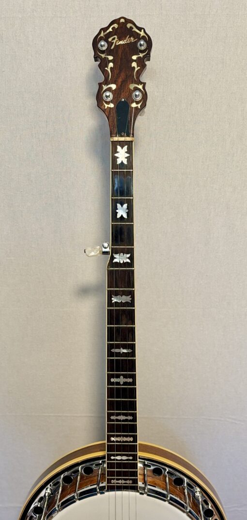 Neck and peghead of a 1960s Fender Artist banjo showing Fender logo and pearl scrollwork inlay