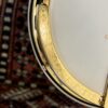 Gold-plated engraved armrest on 2005 Gibson RB-18 Top Tension banjo showing Art Deco pattern