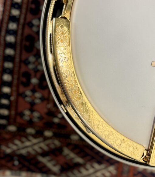 Gold-plated engraved armrest on 2005 Gibson RB-18 Top Tension banjo showing Art Deco pattern