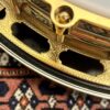 Closeup of gold-plated engraved flange on 2005 Gibson RB-18 Top Tension banjo showing Art Deco geometric pattern