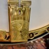 Gold-plated engraved tailpiece on 2005 Gibson RB-18 Top Tension banjo showing Art Deco geometric pattern