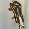 Peghead of 2005 Gibson RB-18 Top Tension showing pearl script Gibson logo and Art Deco torch inlay with gold tuners