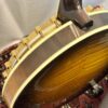 Closeup of gold-plated engraved flange on 2005 Gibson RB-18 Top Tension banjo showing Art Deco geometric pattern