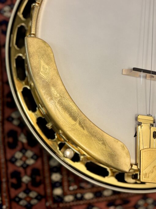 Closeup of engraved gold armrest with decorative pattern