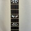 Middle fret section with ornate pearl inlay patterns on ebony fingerboard