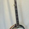 Side view of Shelby Blackhawk banjo showing mahogany resonator with cream binding