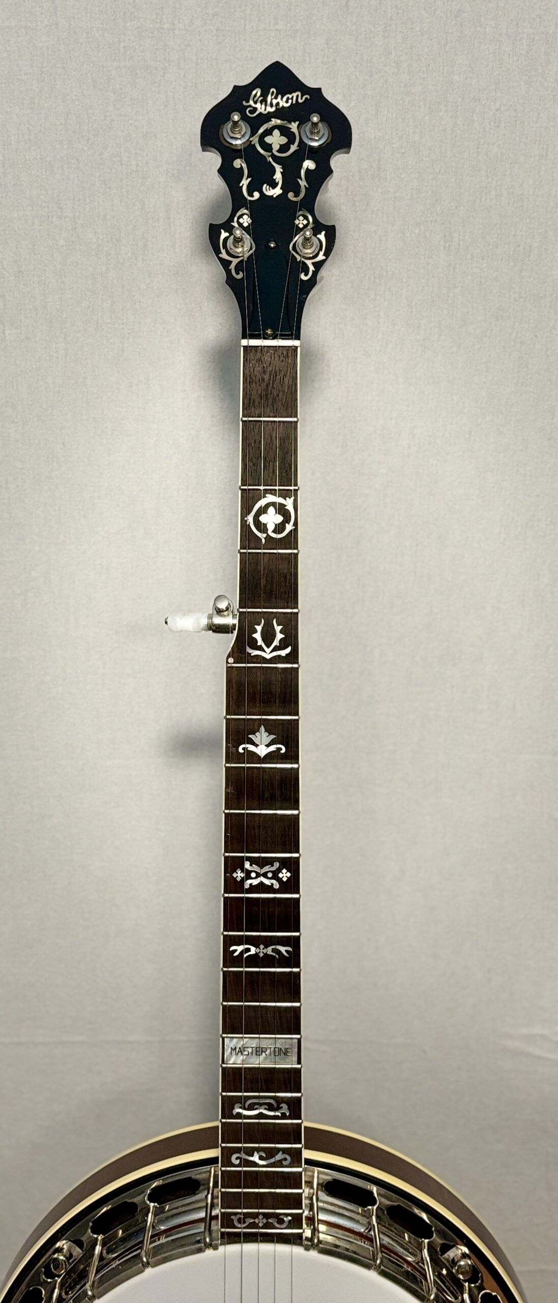 Gibson RB-3 banjo neck showing wreath pattern pearl inlays on rosewood fretboard, Gibson logo headstock with ornate pearl inlay, and Mastertone block at 22nd fret