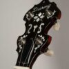 Deering Golden Era banjo front peghead angled view showing pearl inlay detail and ebony overlay