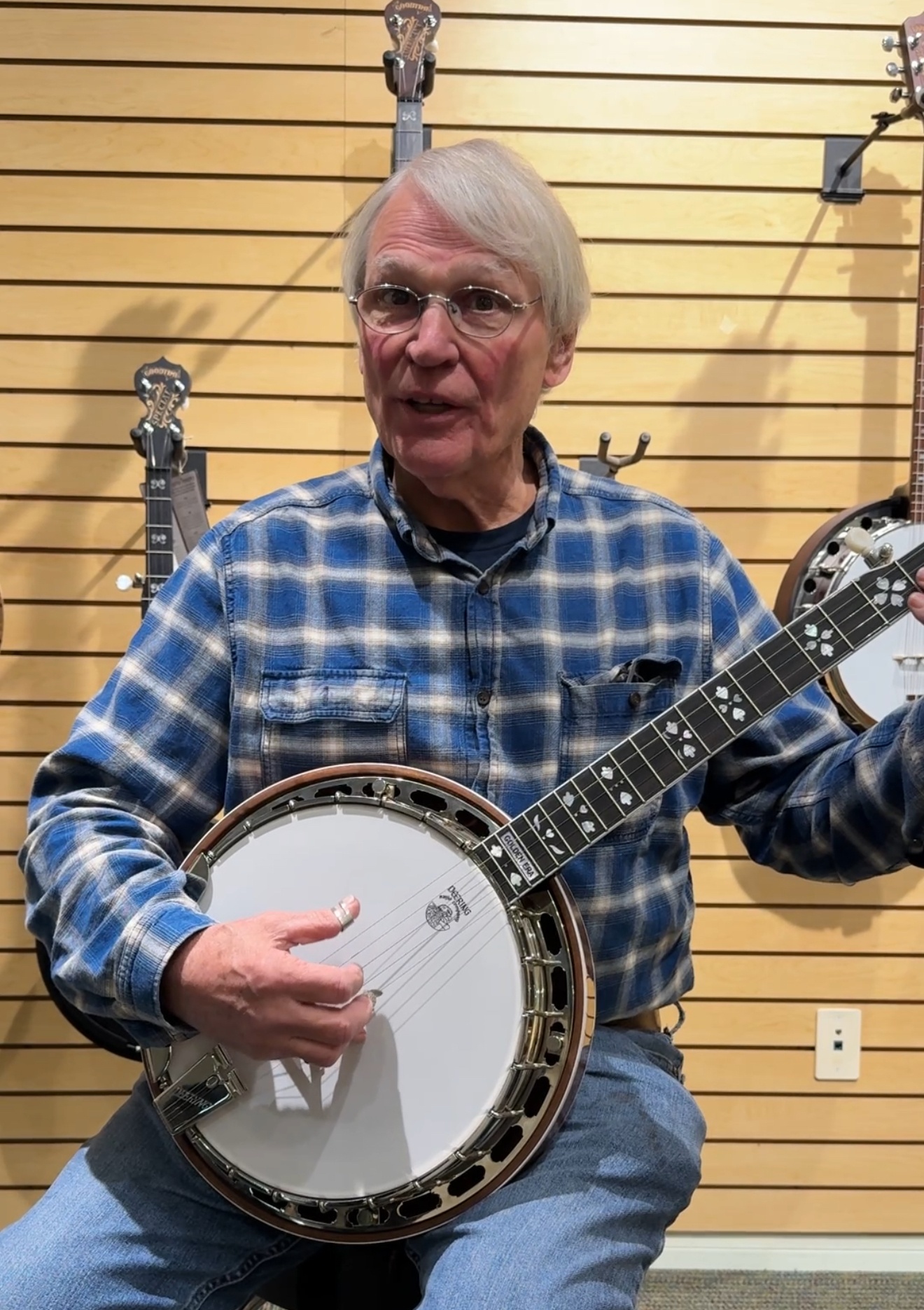 Geoff Hohwald holding Deering Golden Era banjo with hearts and flowers inlays at the Deering factory in Spring Valley California