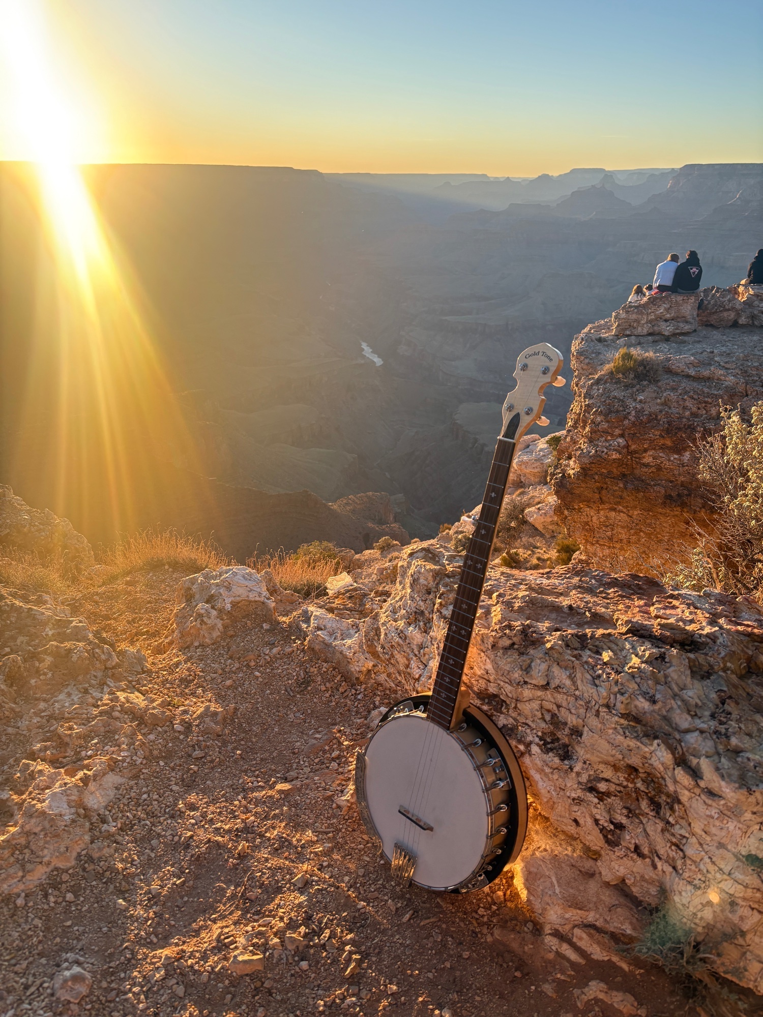 Gold Tone CC-100R banjo at Grand Canyon South Rim at sunset with canyon vista and visitors in background