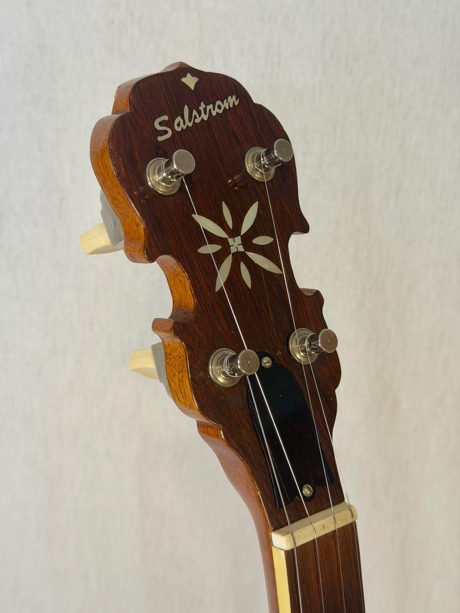 Salstrom B5-C banjo headstock front with Salstrom name and pearl flower inlay