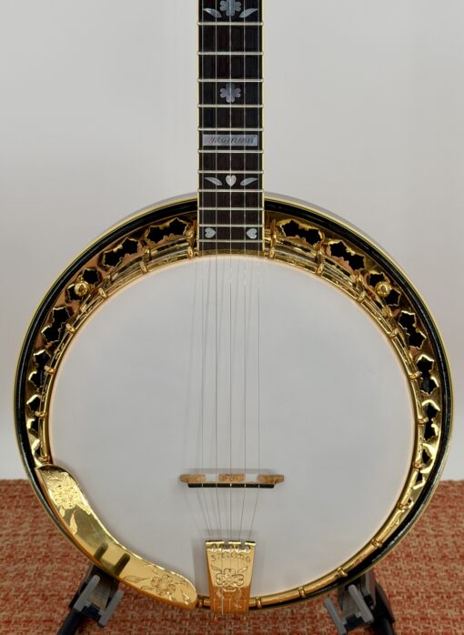 Front view of the 1987 Stelling One-Bird Virginian, serial 3149, showing the gold-plated flange with hand-engraved Dogwood motif, the proprietary Stelling tone ring, the engraved Stelling tailpiece, and the walnut neck with mother-of-pearl Dogwood fingerboard inlays.