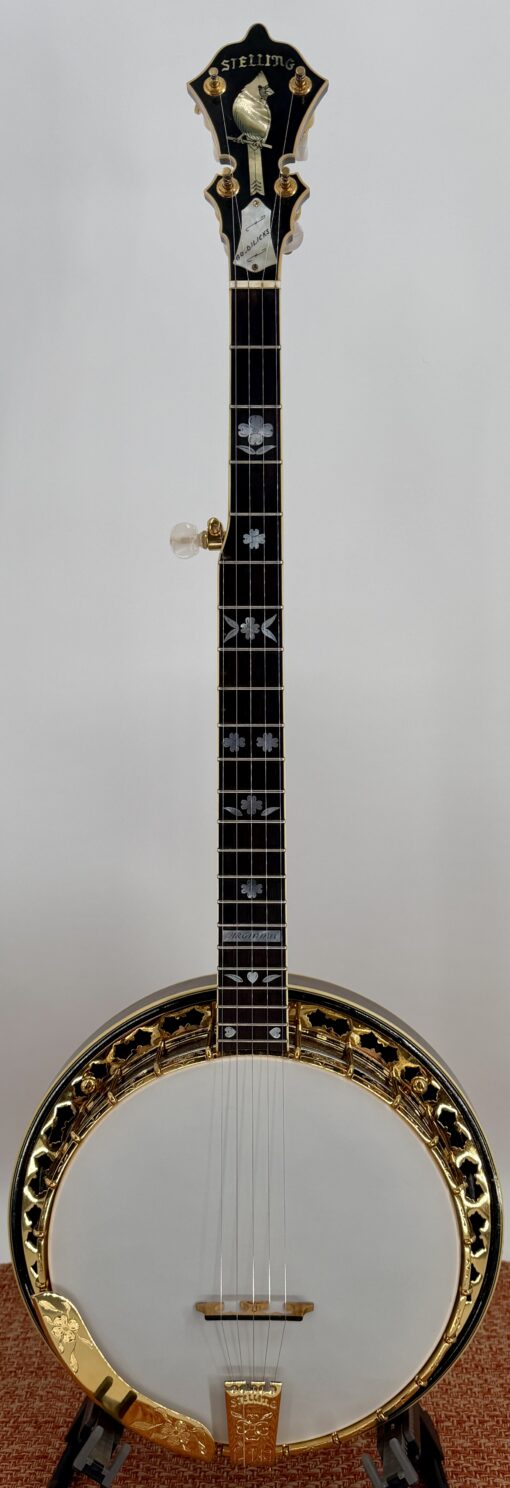 Full-length front view of the 1987 Stelling One-Bird Virginian, serial 3149, from headstock to tailpiece. Visible from top to bottom: the Stelling headstock with the mother-of-pearl Cardinal inlay that defines the One-Bird era, the walnut neck with mother-of-pearl Dogwood fingerboard inlays, the VIRGINIAN model inlay above the body, the proprietary Stelling tone ring, the gold-plated flange with hand-engraved Dogwood cutouts, and the engraved Stelling tailpiece.