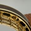 Huber Truetone Custom 625-13 detail of the curly maple Granada-style resonator edge meeting the engraved gold Style 6 flange Detail of the curly maple Granada resonator and engraved gold flange on the Huber Truetone Custom 625-13.