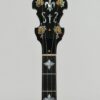 Side view of the Huber Truetone Custom 625-13 engraved gold armrest, flange, and curly maple resonator edge Side view of the engraved gold armrest and flange on the Huber Truetone Custom 625-13.