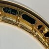 Macro detail of the Huber Truetone Custom 625-13 engraved gold-plated Style 6 flange with hand engraving and the serial number 625-13 visible through the flange cutout Macro of the hand-engraved gold Style 6 flange on the Huber Truetone Custom 625-13, with serial number 625-13 visible in the cutout.