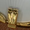 Huber Truetone Custom 625-13 showing the engraved gold-plated tailpiece and engraved armrest against the white head The engraved gold tailpiece and armrest of the Huber Truetone Custom 625-13.