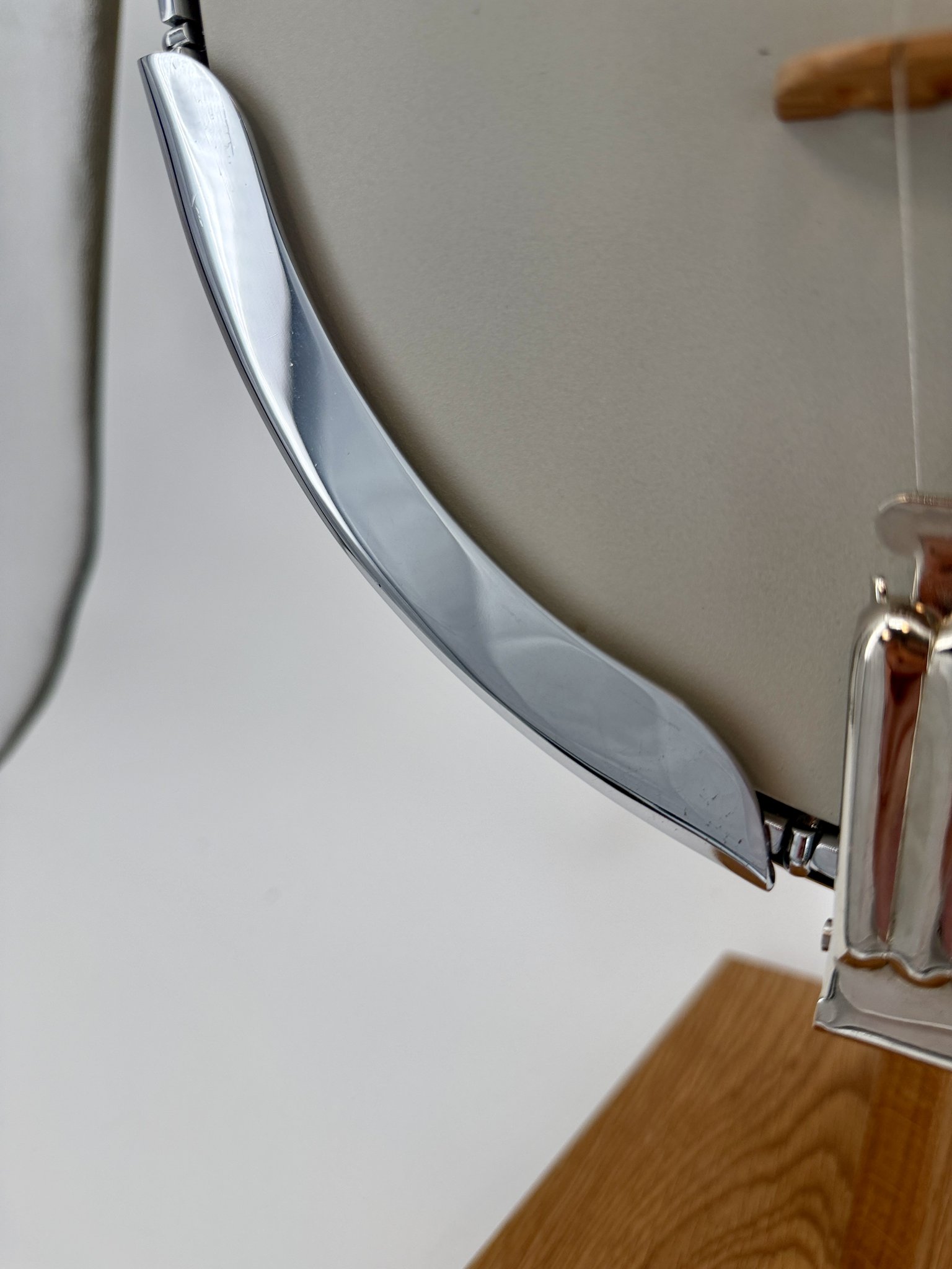Chrome armrest detail on a 1970s GTR banjo showing light vintage wear