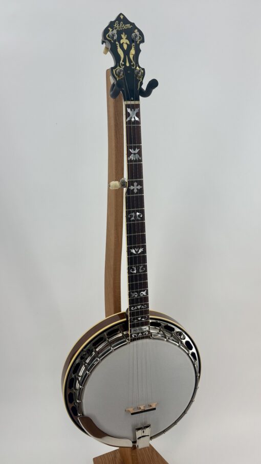 Front view of the 1990 Gibson RB-4 on a stand, showing the burl walnut neck and the resonator
