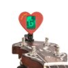 Gold Tone Fleck Tune clip-on tuner, red heart-shaped body clipped to a banjo headstock with the green display reading G in chromatic mode