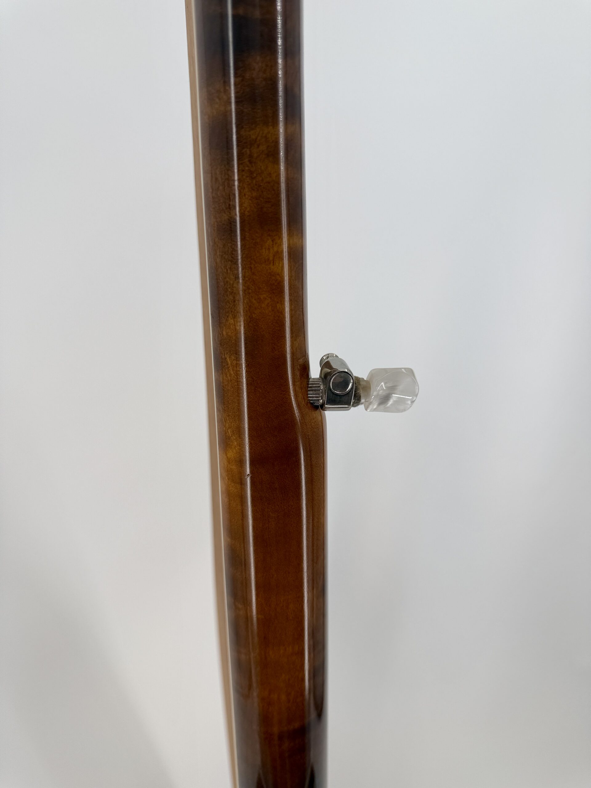 Side view of the Stelling Sunflower neck with the geared fifth string tuner