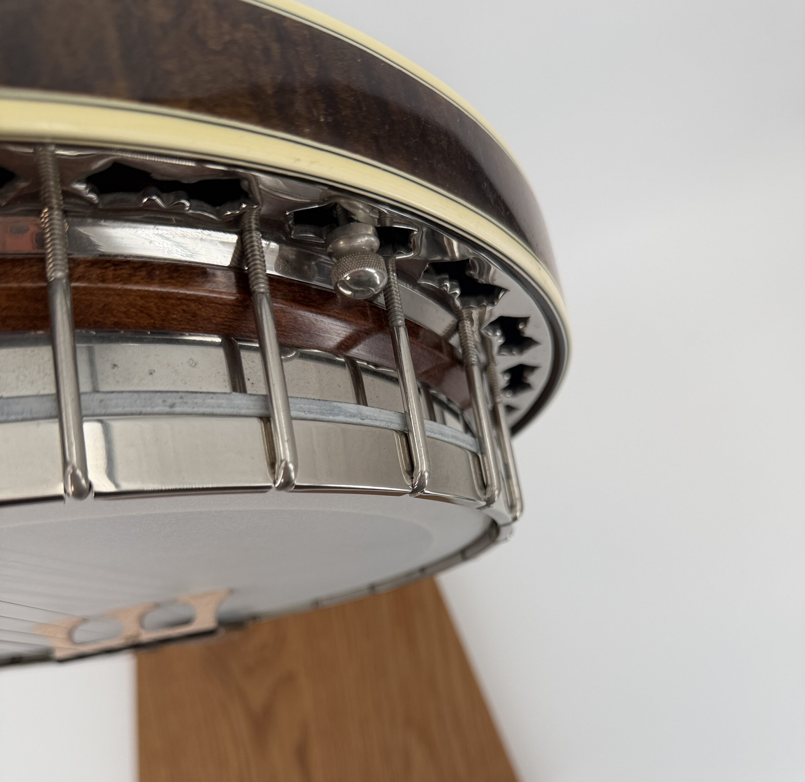 Underside view of the Stelling Sunflower flange, bracket band, and figured maple resonator rim