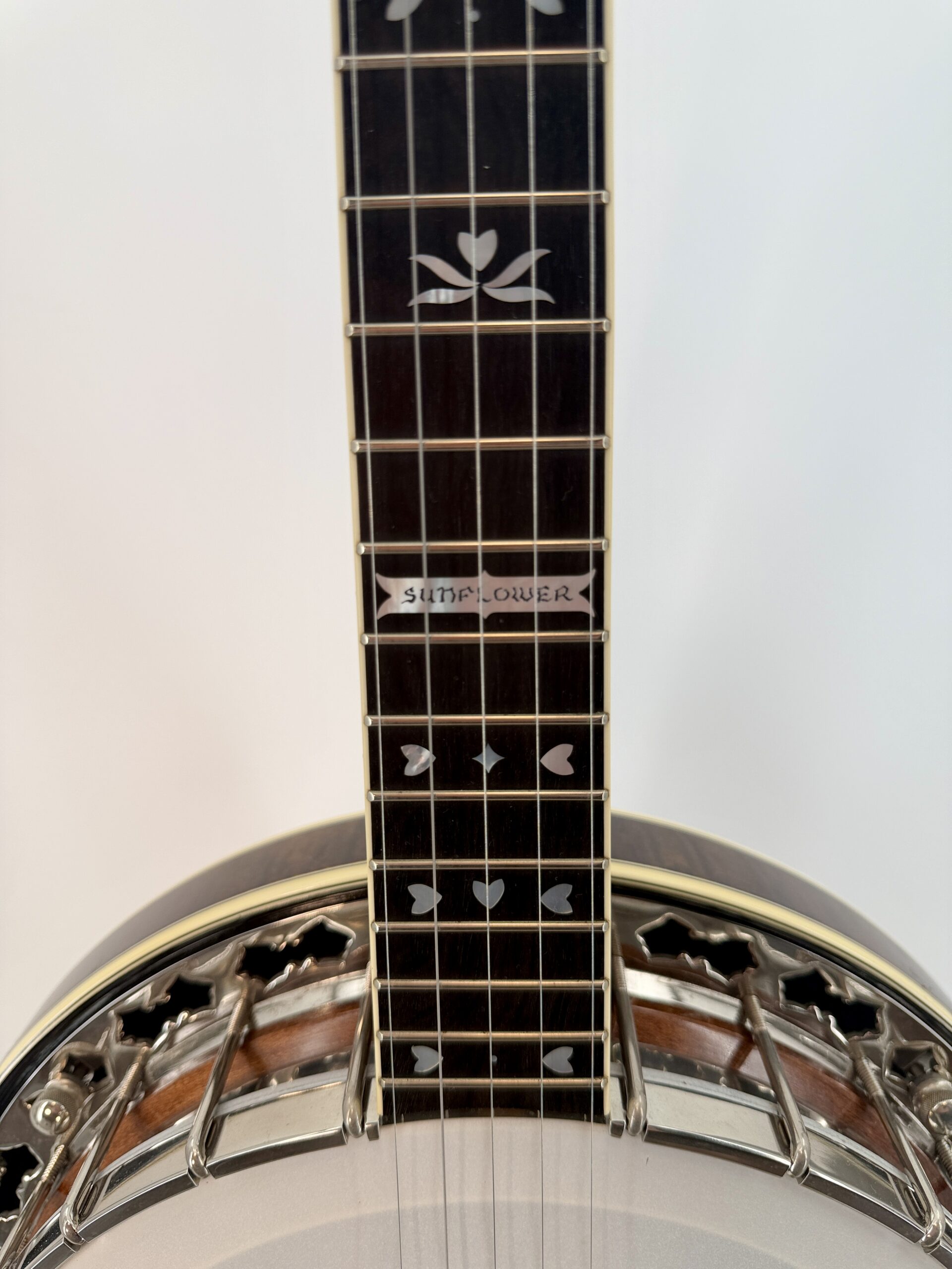 Stelling Sunflower fingerboard showing the SUNFLOWER banner inlay and pearl heart and flower inlays