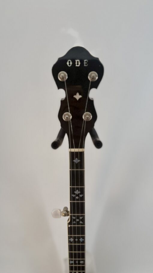 Block-letter ODE logo and fleur-de-lis inlay on the peghead of a 1980 ODE Style C