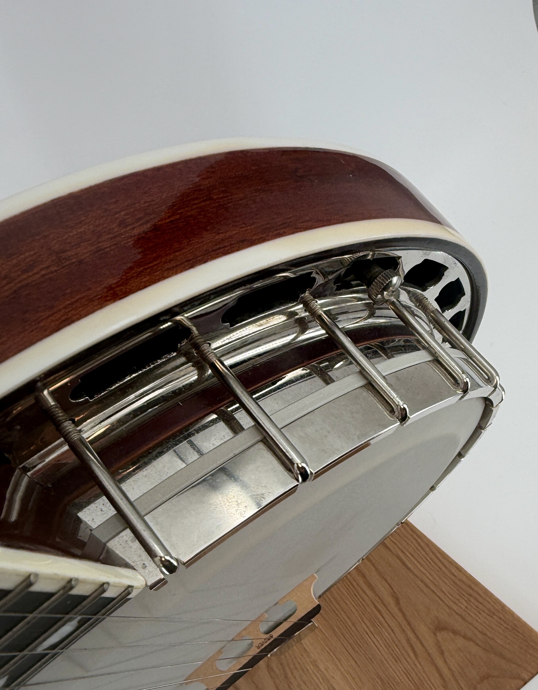 2010 Flint Hill FHB-280A banjo with a side view of the bound mahogany resonator, flange and resonator hooks, at Banjo Warehouse in Yellow Springs, Ohio.
