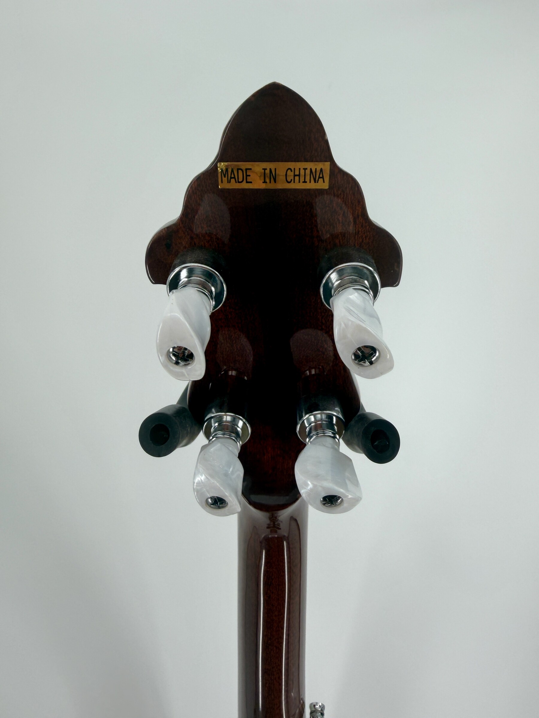 2010 Flint Hill FHB-280A banjo with the back of the peghead and its four white-button tuners, at Banjo Warehouse in Yellow Springs, Ohio.