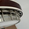 Side of the resonator and flange of a Clancy Mullins banjo