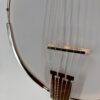 Deering Goodtime Six-R six-string resonator banjo with a close view of the bridge and tailpiece on the head, at Banjo Warehouse in Yellow Springs, Ohio.