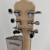 Deering Goodtime Six-R six-string resonator banjo with a back view of the peghead and six tuners with the factory hang tag, at Banjo Warehouse in Yellow Springs, Ohio.