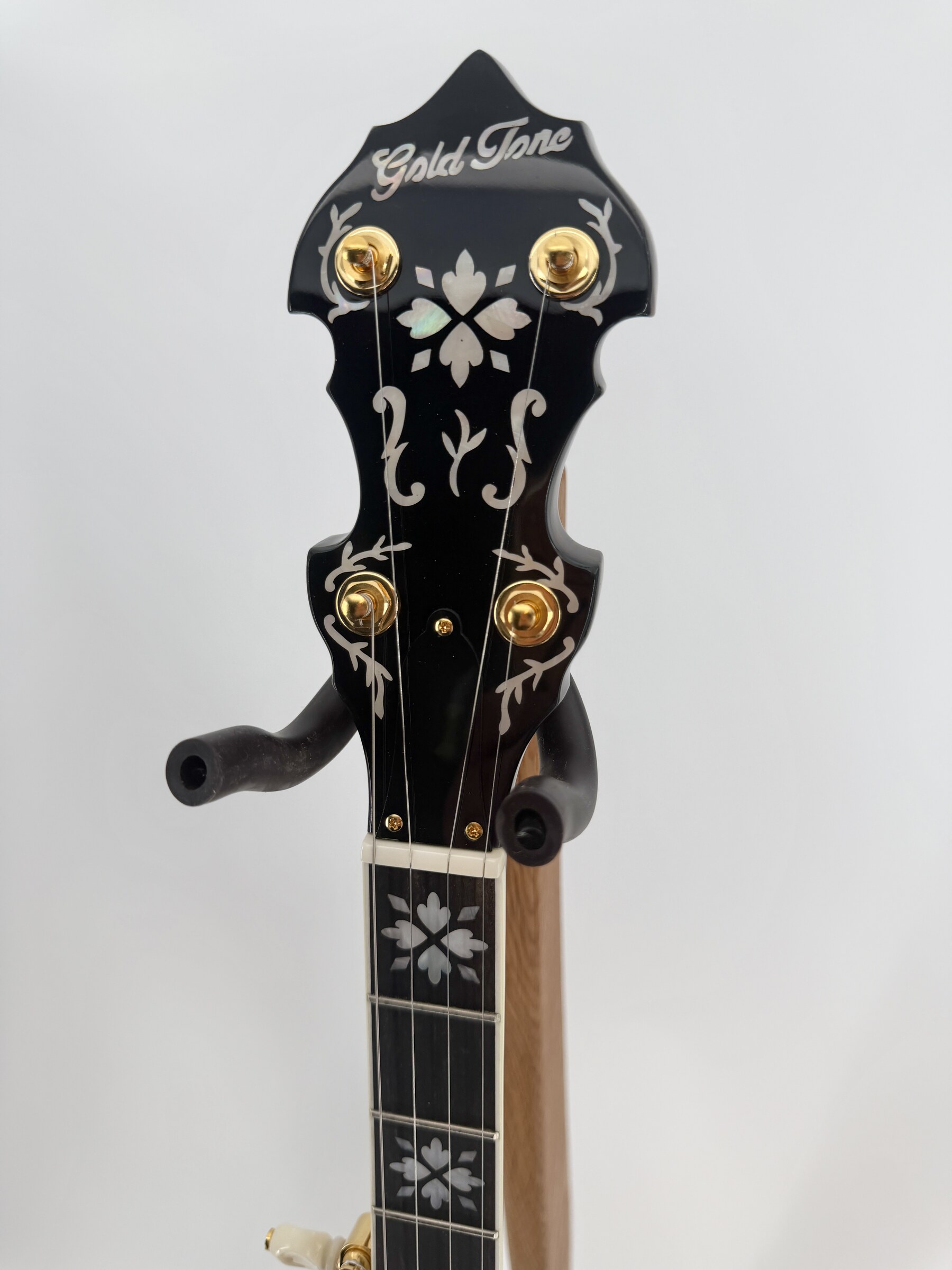 Double-cut peghead with Gold Tone logo and gold plated tuners