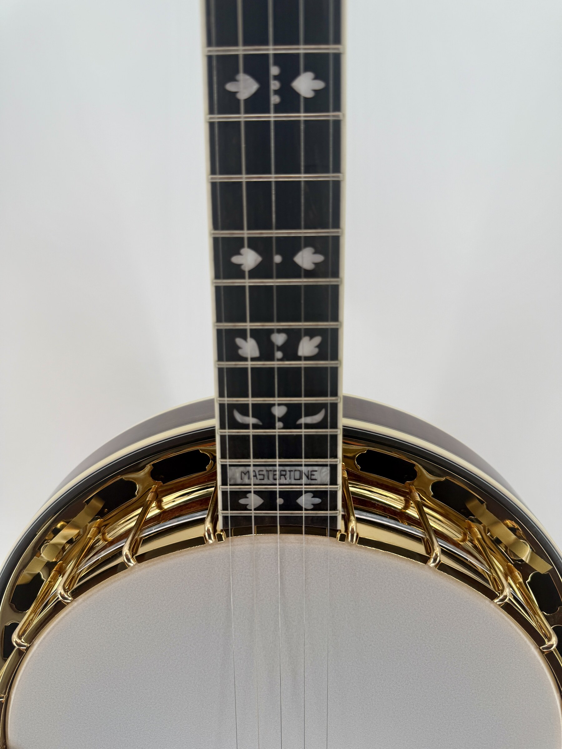 Hearts and Flowers inlay on the ebony fingerboard, where the neck meets the pot