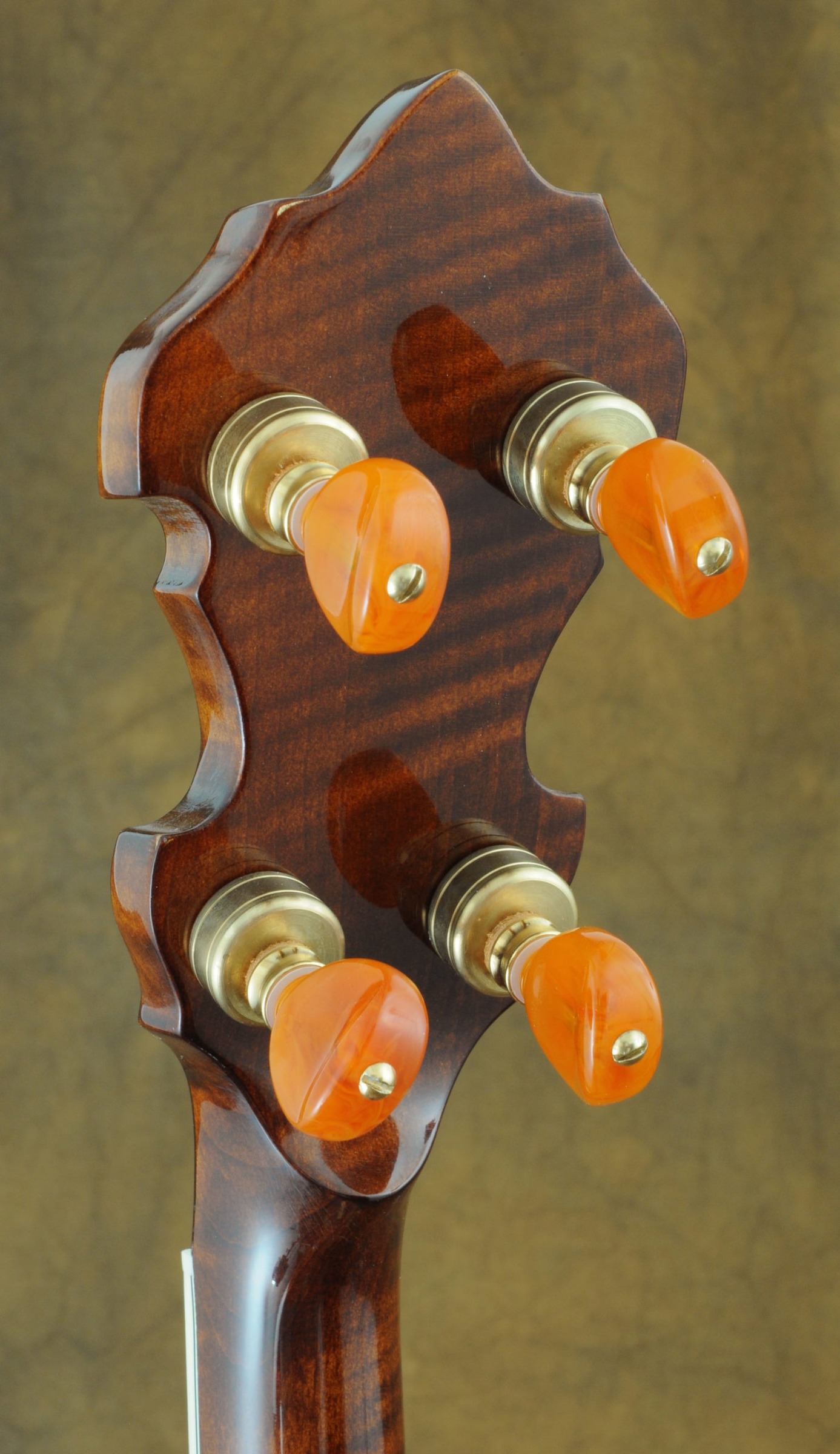 Back of a Huber VRB-G peghead with amber tuner buttons (Huber catalog photo)
