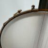 Pisgah Tubaphone 12-inch openback banjo with a close view of the notched brass hoop and hooks beside the neck heel, at Banjo Warehouse in Yellow Springs, Ohio.