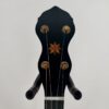 Pisgah Tubaphone 12-inch openback banjo with the peghead showing its star inlay and four tuners, at Banjo Warehouse in Yellow Springs, Ohio.