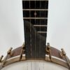 Pisgah Tubaphone 12-inch openback banjo with the scooped end of the fingerboard above the pot, at Banjo Warehouse in Yellow Springs, Ohio.